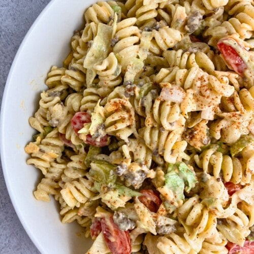 A white serving bowl of cheeseburger pasta salad.