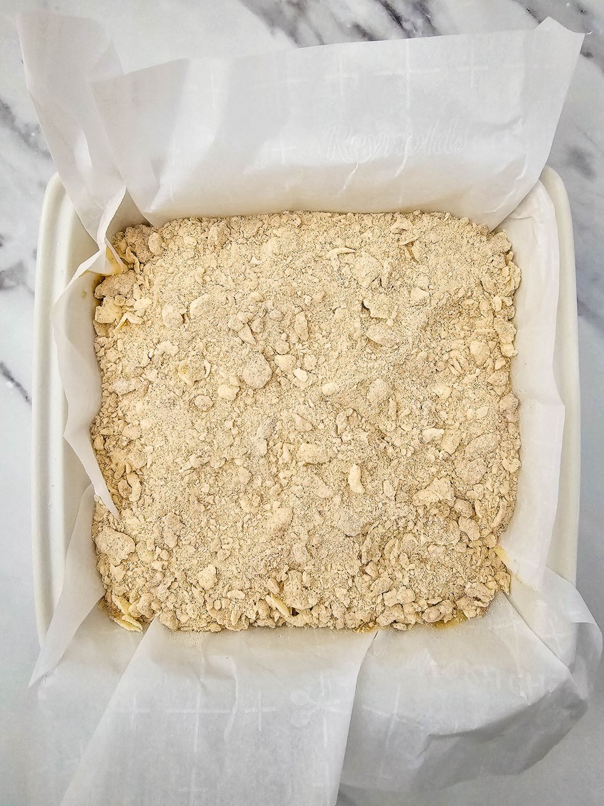 Crumb topping spread over the top of the cake.