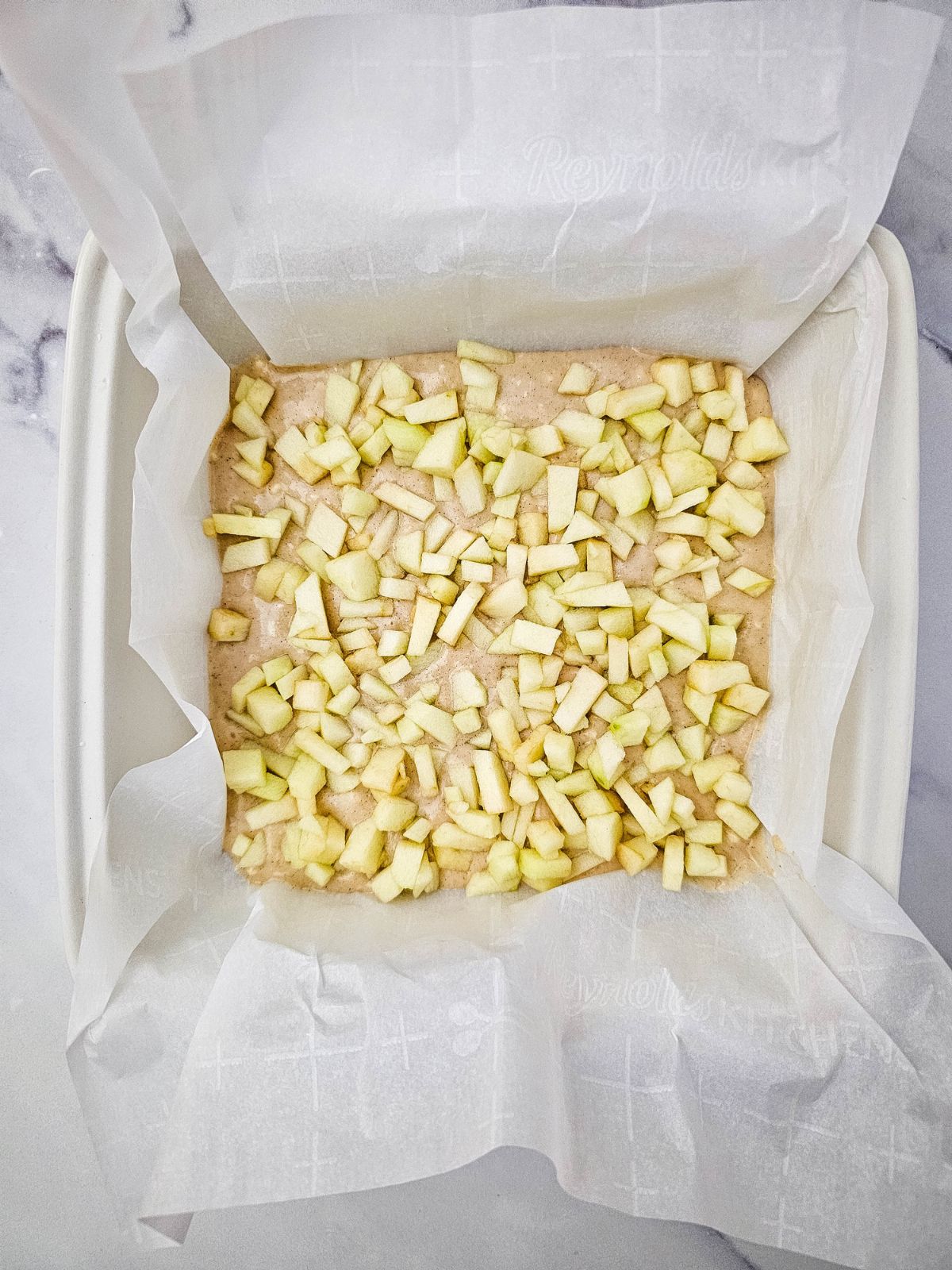 Diced apple spread over the cake batter.