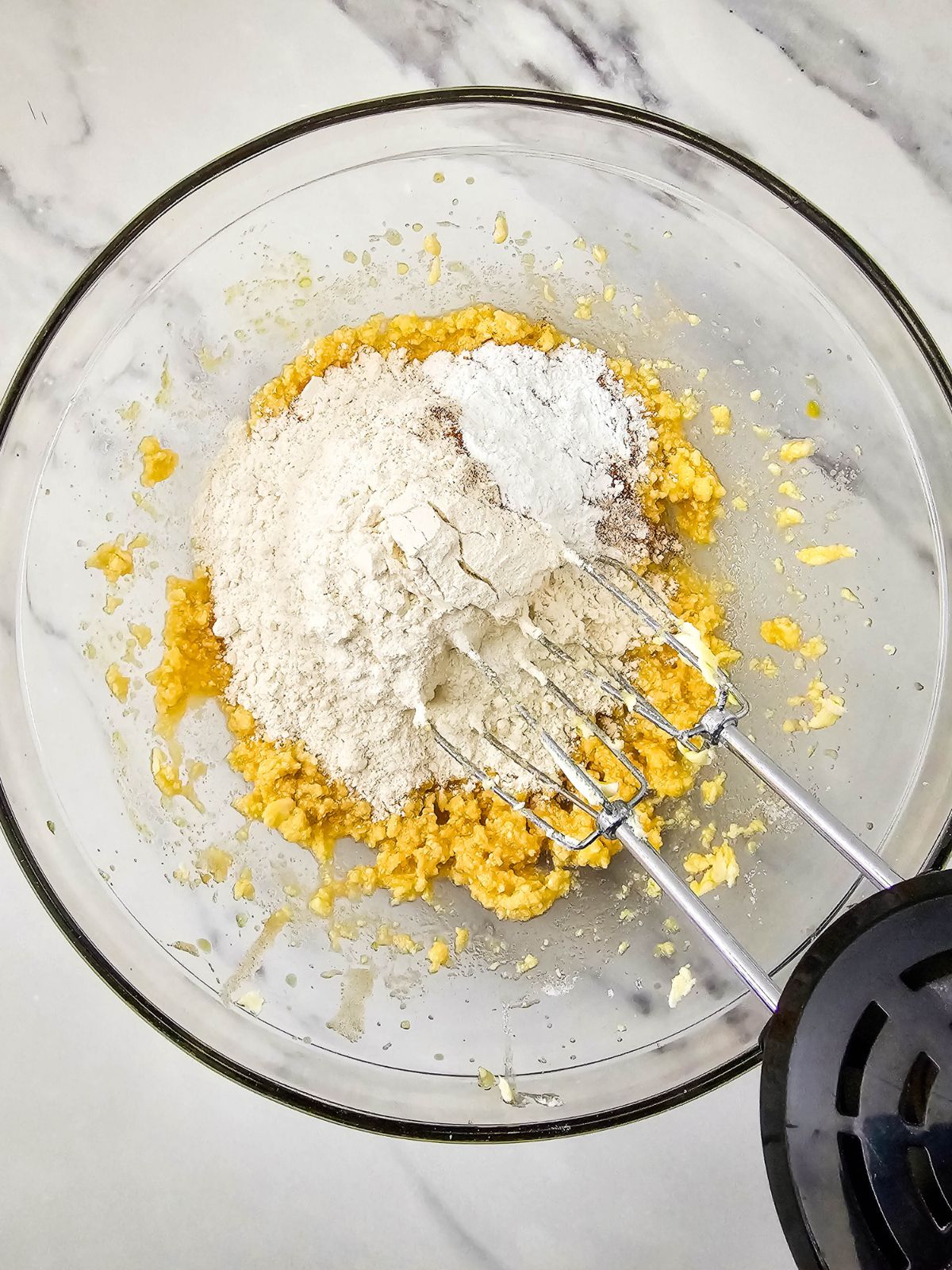 Dry ingredients are added to the wet cake ingredients.