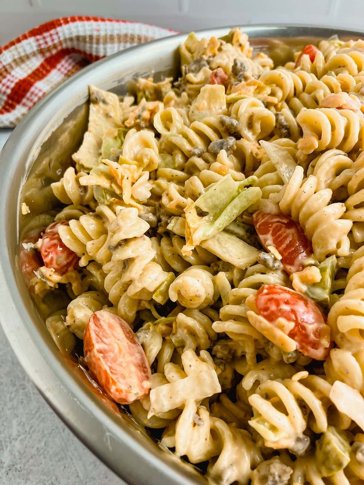 A large batch of homemade cheeseburger pasta salad in a bowl.
