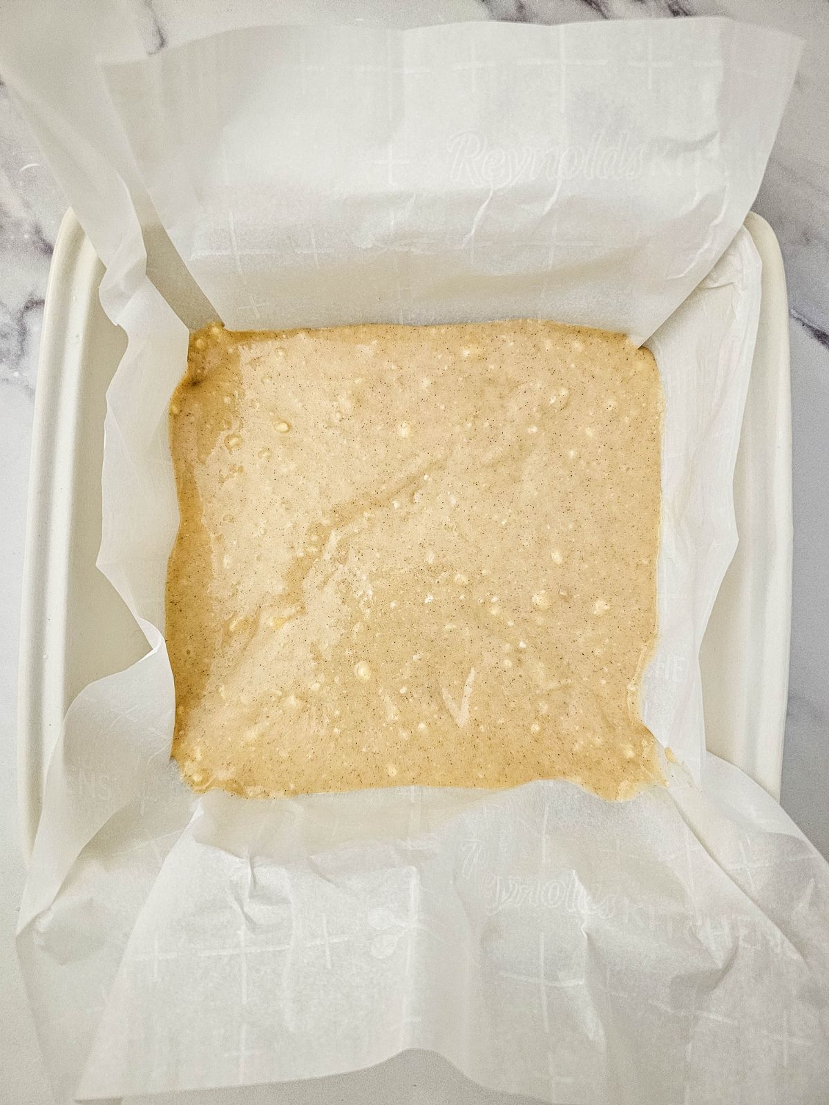 Half of the cake batter was poured into the cake pan.