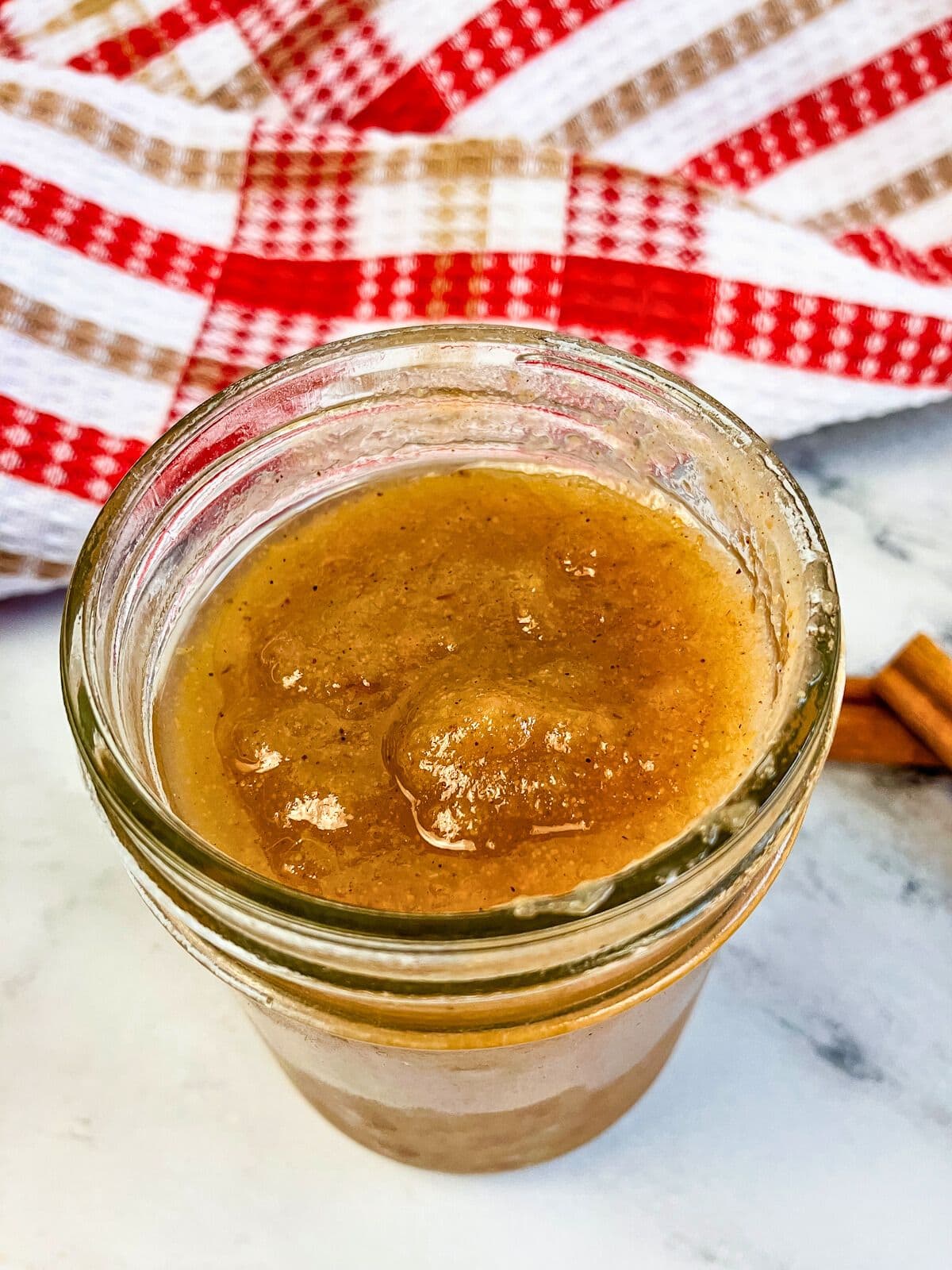 Homemade pear sauce in a mason jar on the counter.