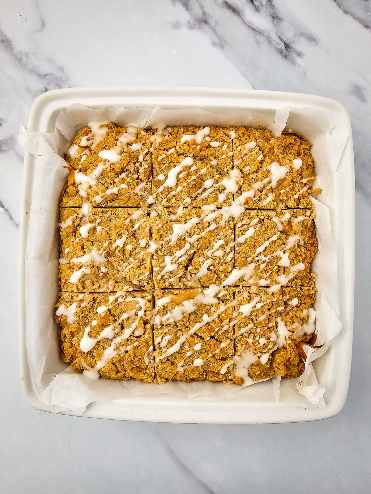 Icing drizzled over the cooled apple cake.