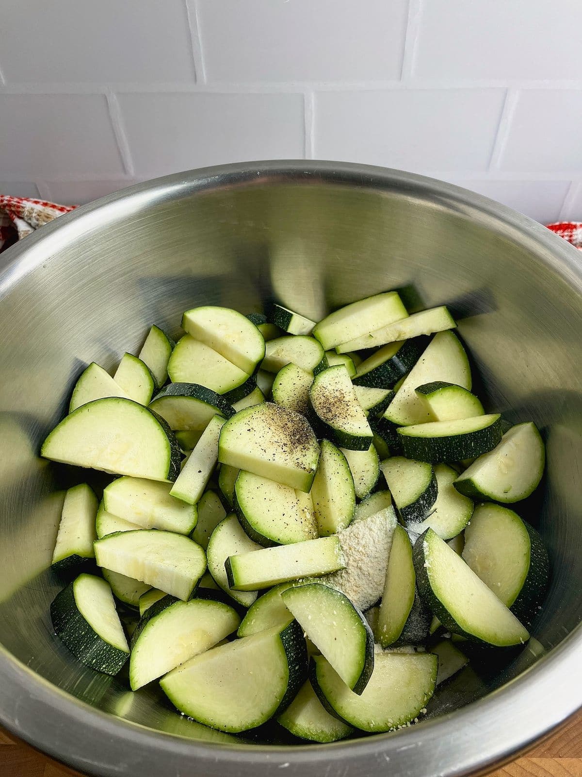 Vegetable oil, salt, pepper, and garlic powder were added on top of the sliced zucchini.