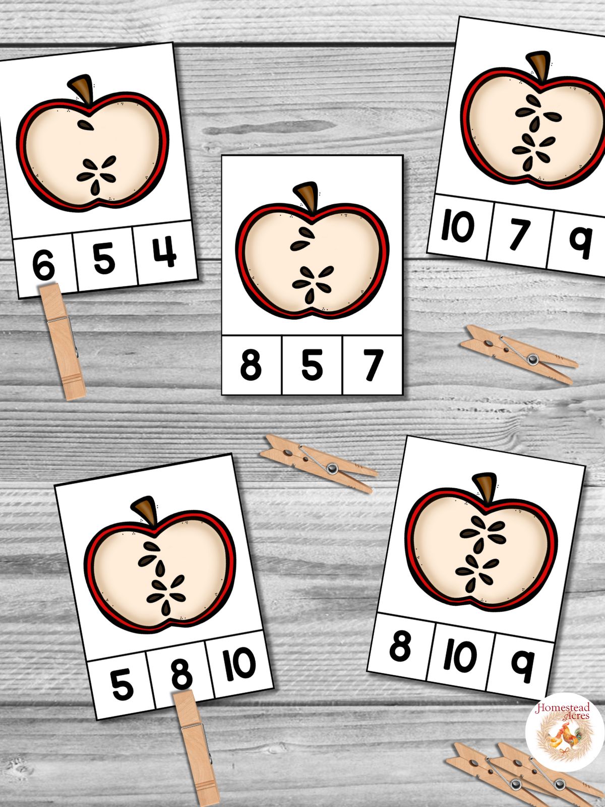Five apple seed count and clip cards on a wooden table background.