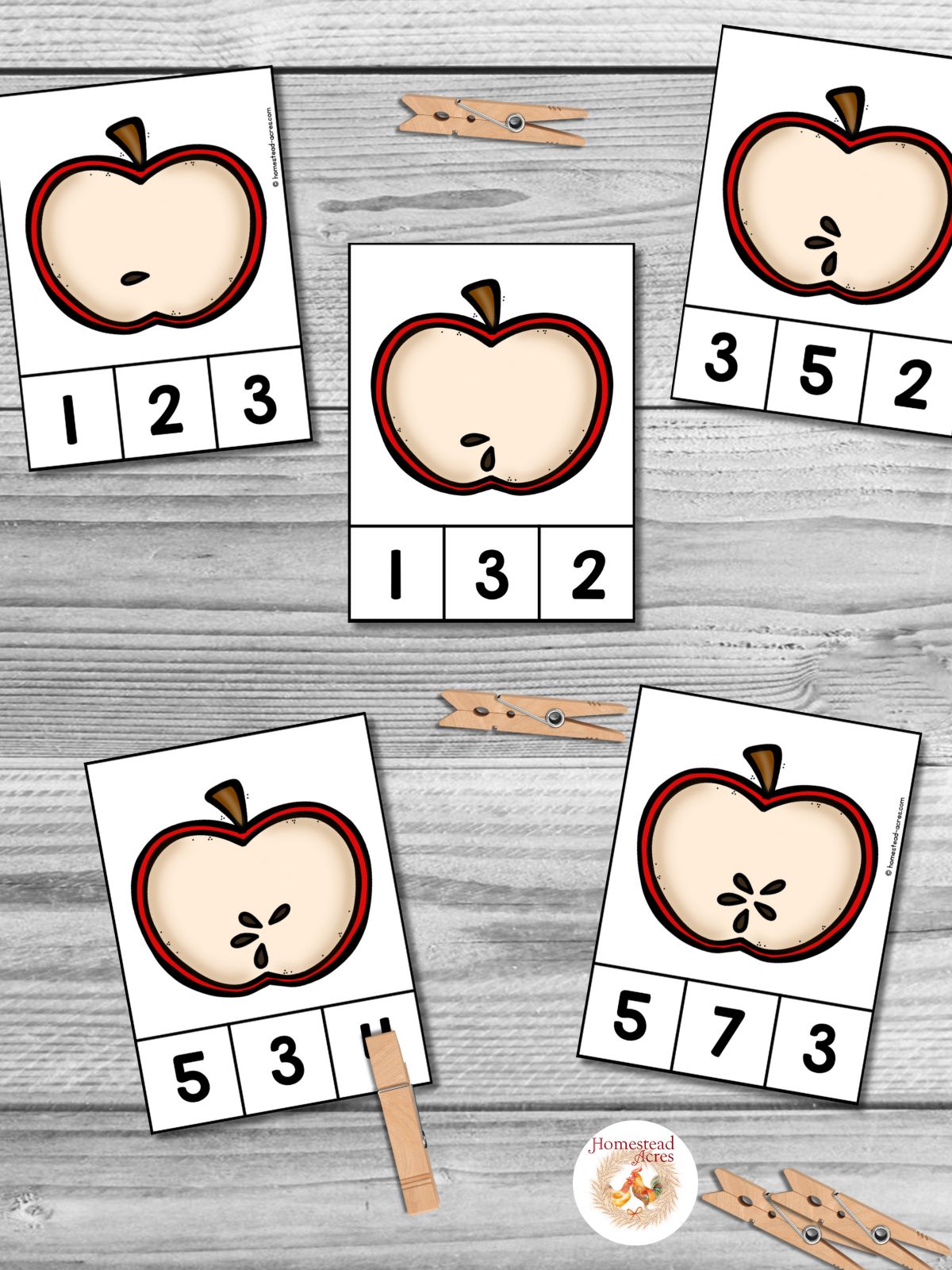 Apple math cards for counting apple seeds sitting on a wooden table.