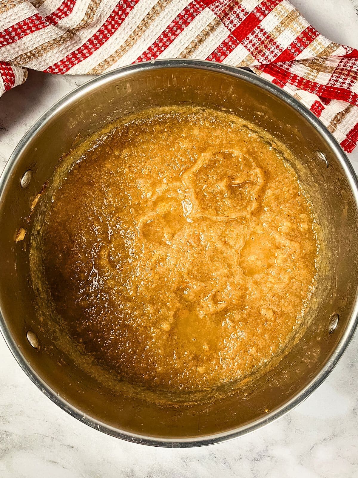 A pot of cooked pear sauce sitting on the counter.