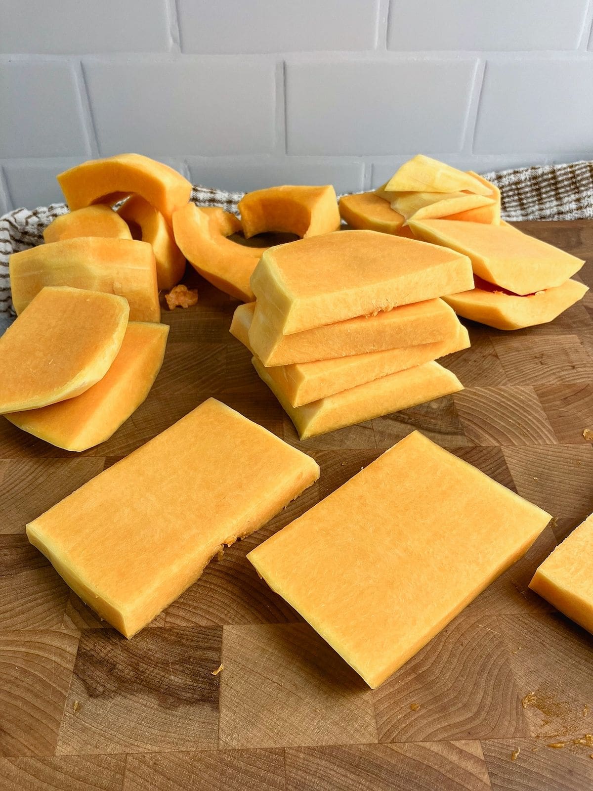 Butternut squash cut into flat slices.