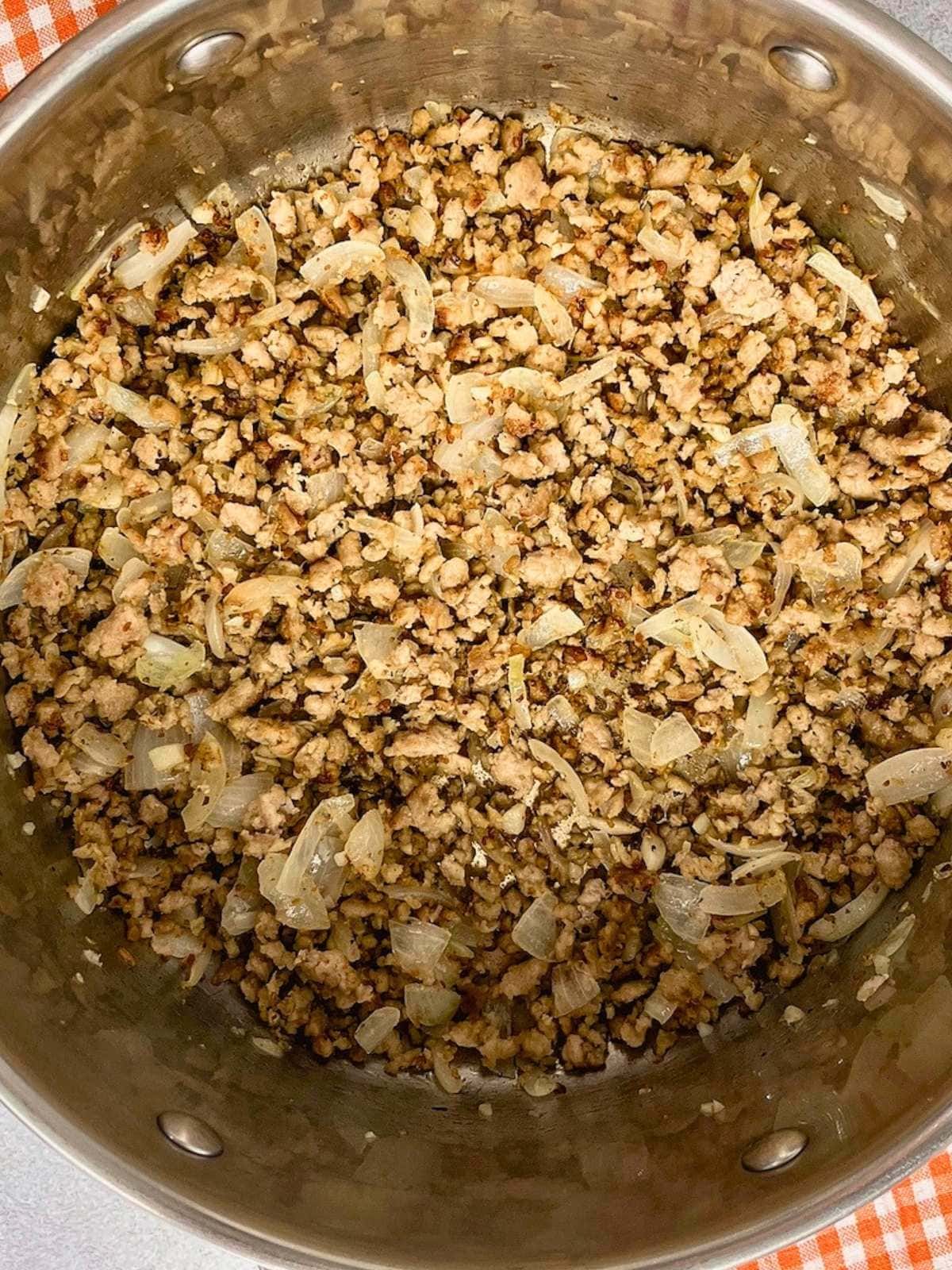 Cooked sausage, onion, and garlic in a large pot.