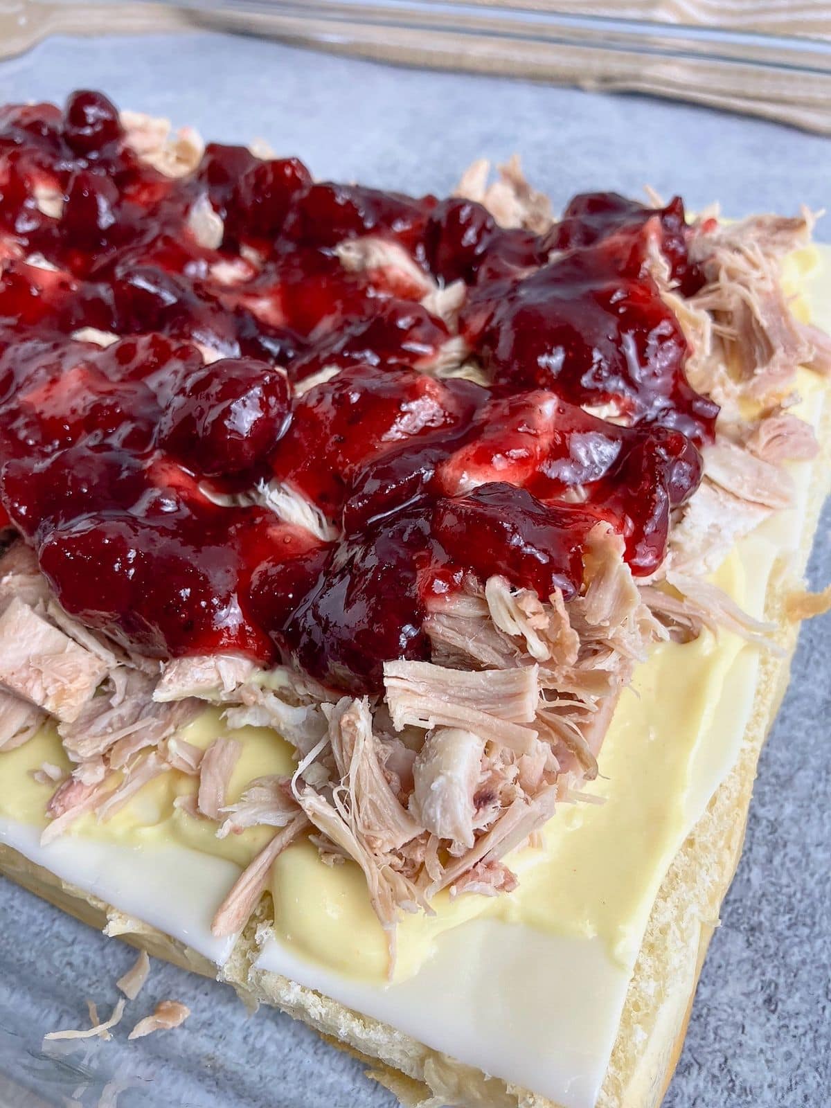 Cranberry sauce spread over the cooked turkey.