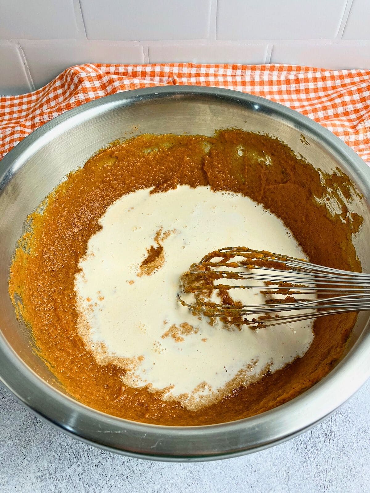 Cream was poured into the pumpkin puree mixture.
