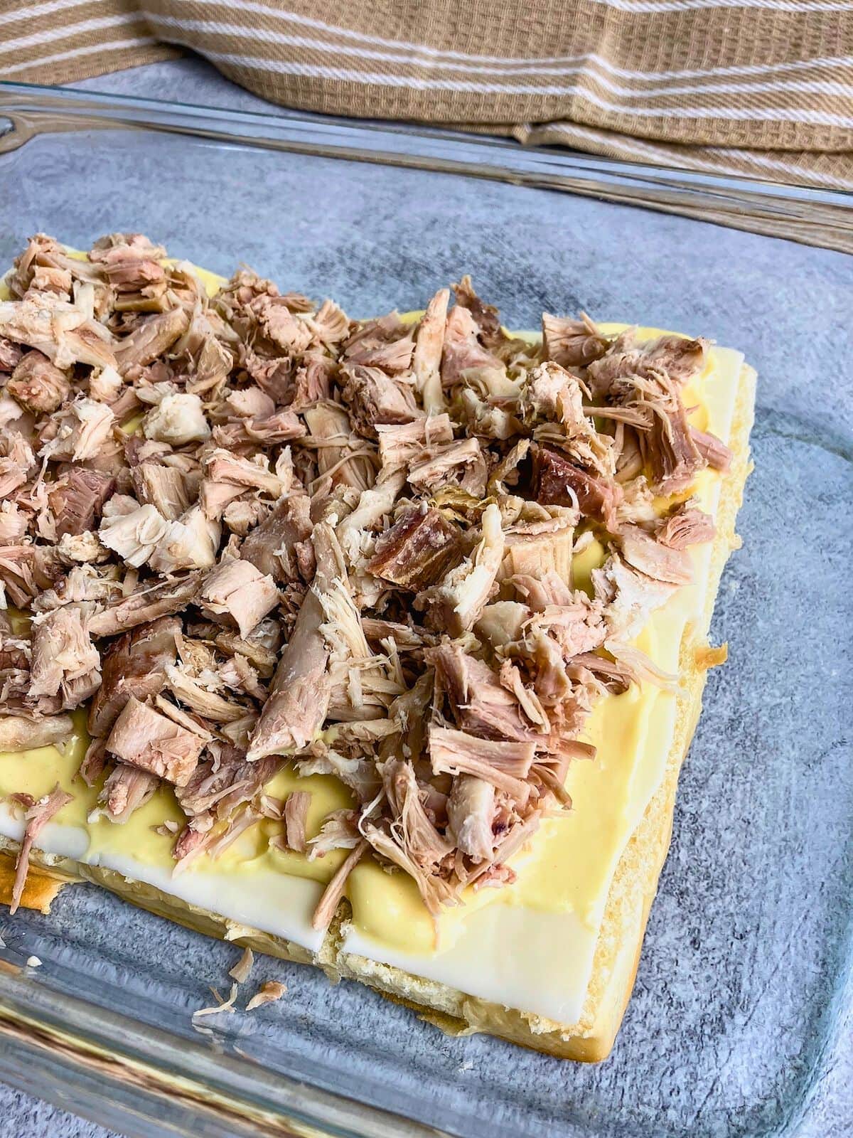 Diced leftover turkey layered over the slider sauce.