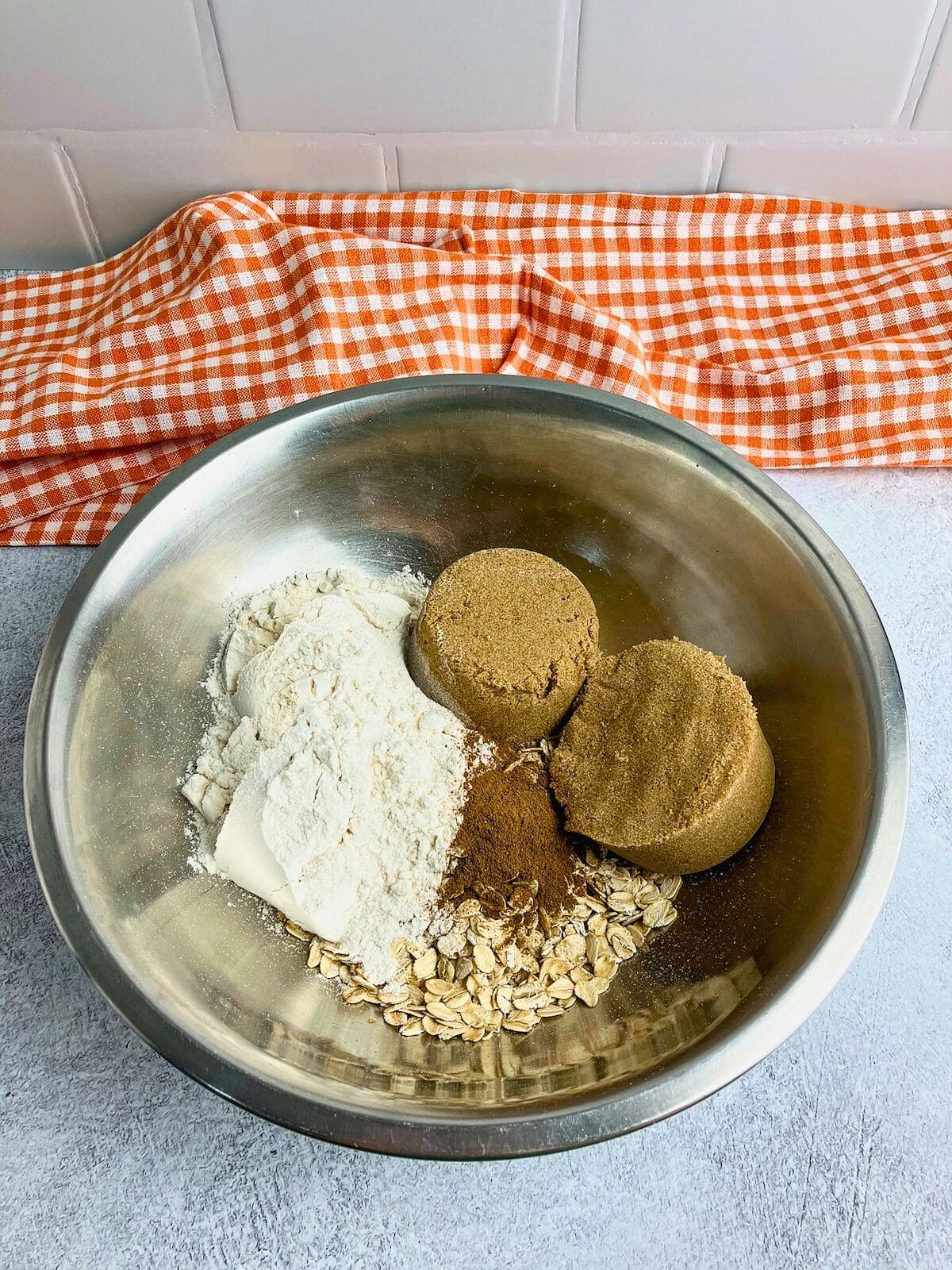 Oats, flour, cinnamon, and brown sugar in a large mixing bowl.