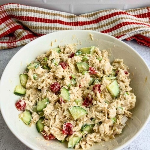 Homemade chicken salad in a large white serving bowl.
