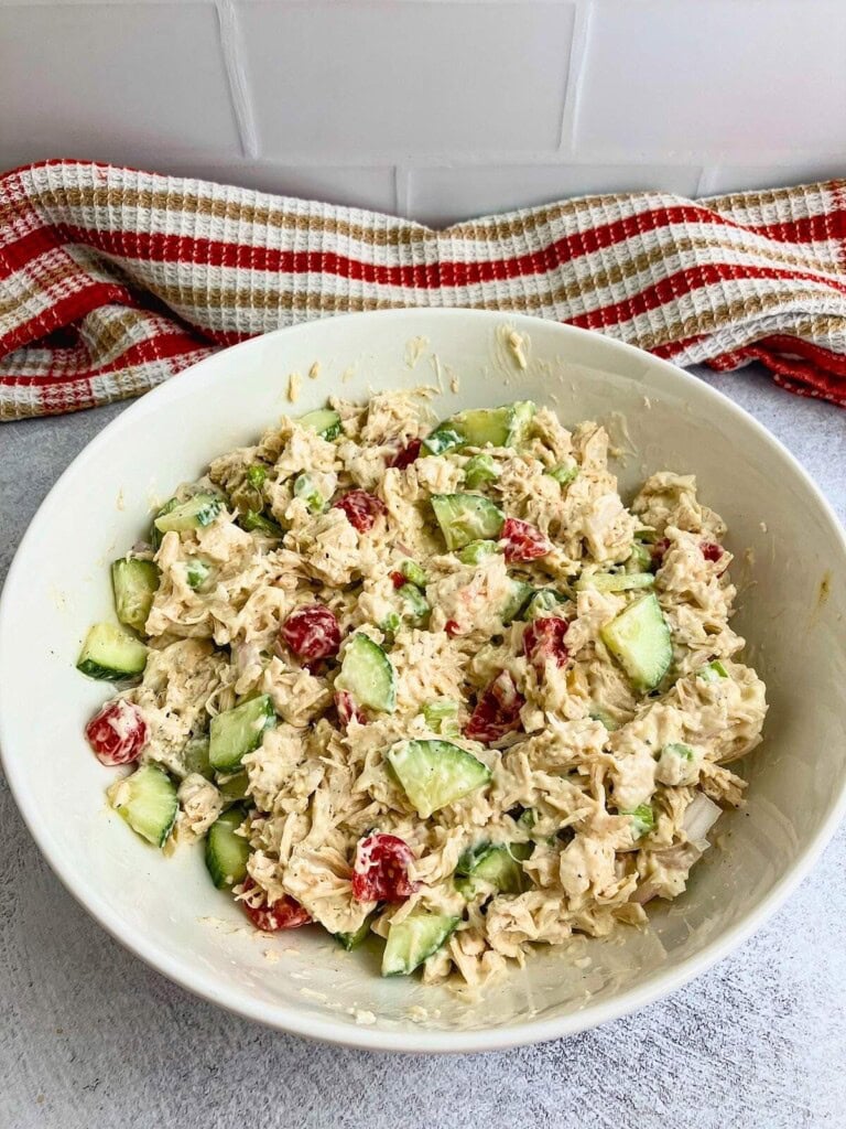 Homemade chicken salad in a large white serving bowl.