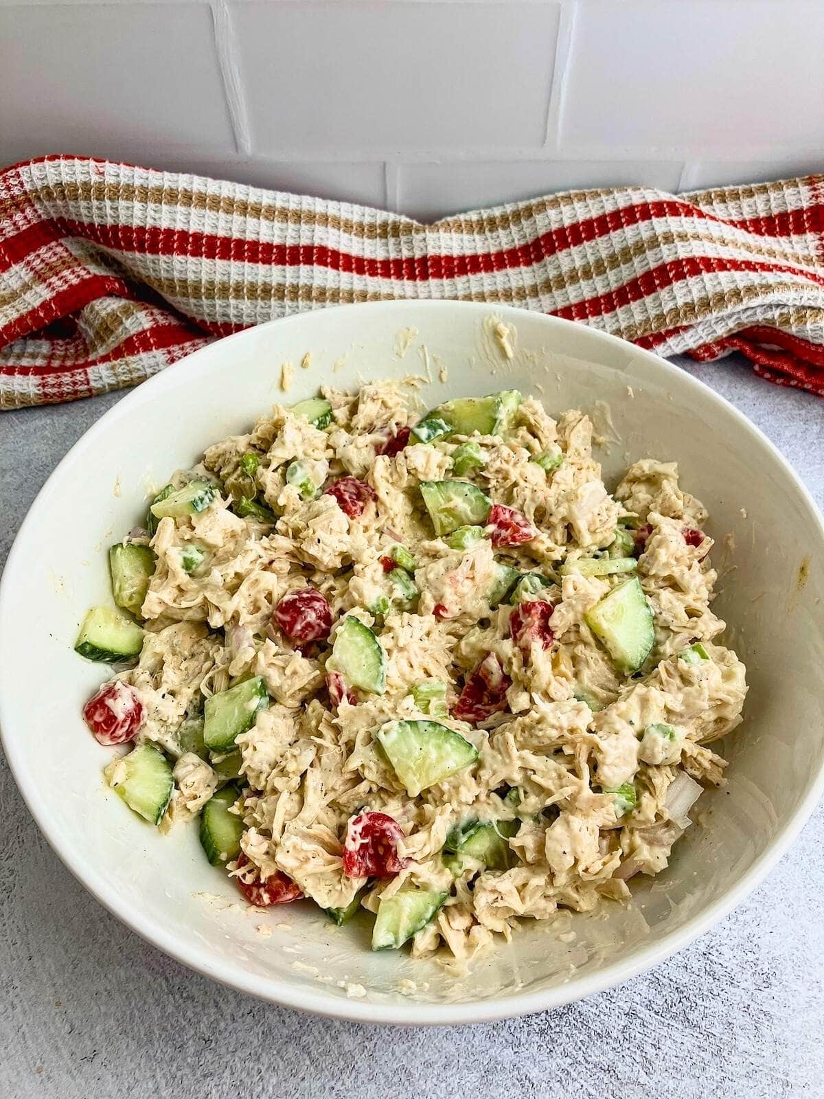Homemade chicken salad in a large white serving bowl.