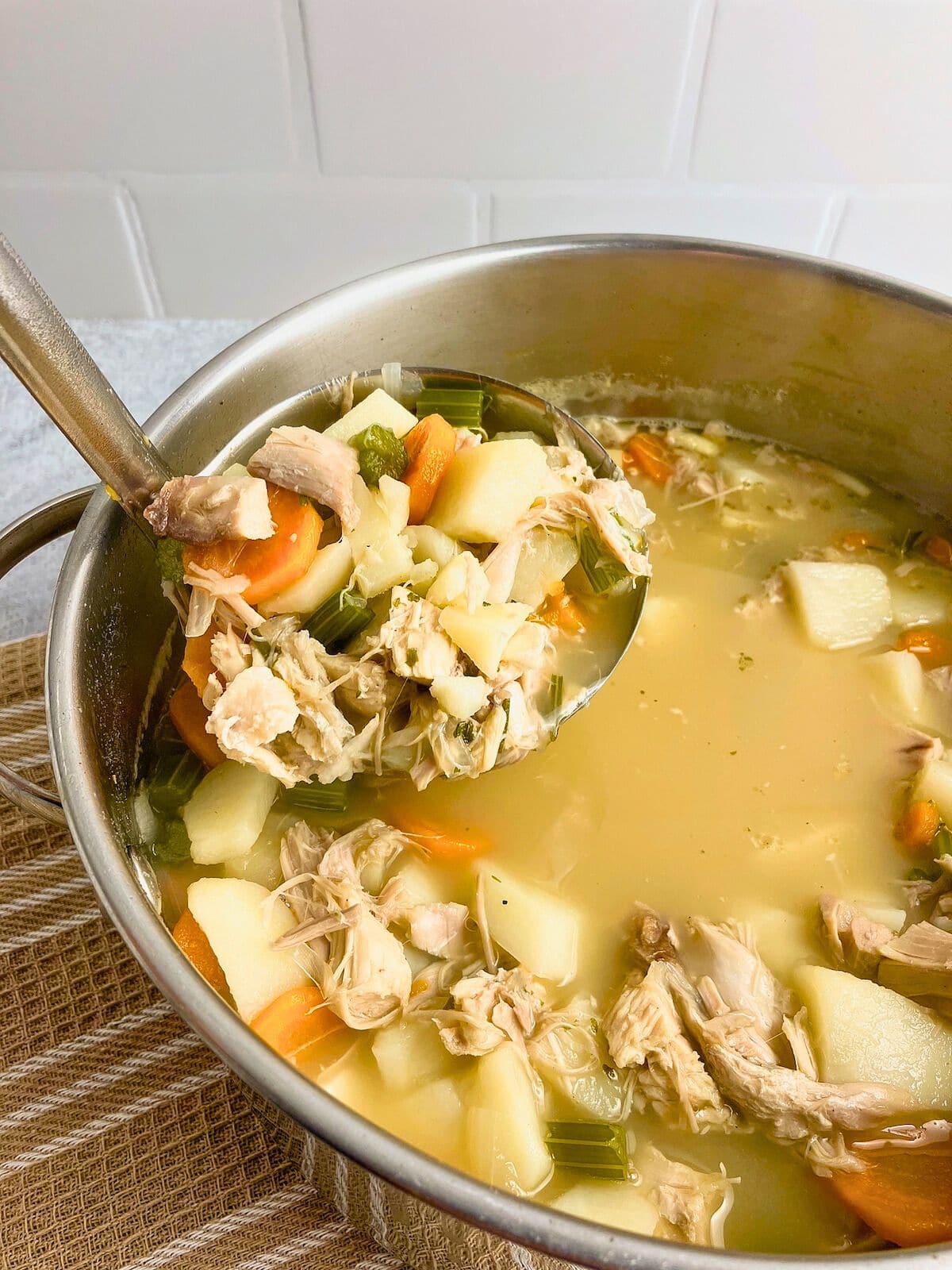 Ladling up leftover turkey soup.
