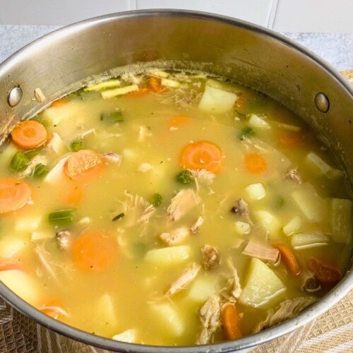 Homemade leftover turkey soup in a large pot.