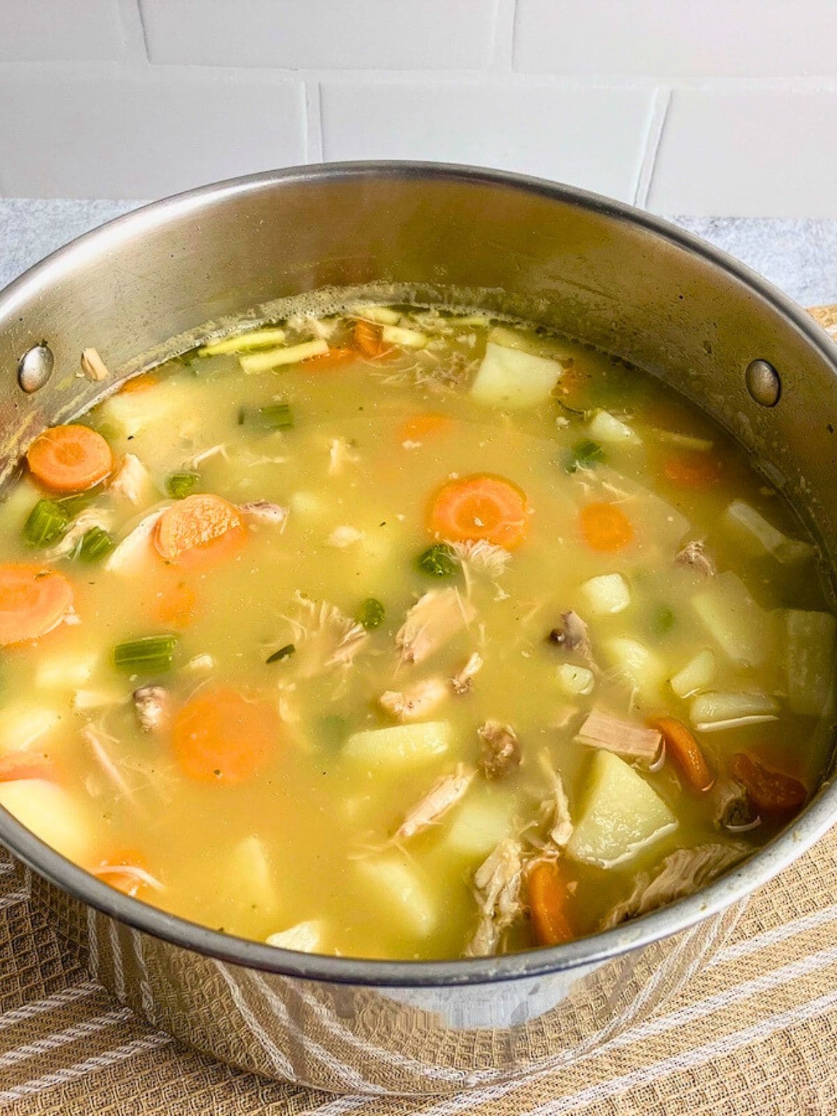 Homemade leftover turkey soup in a large pot.