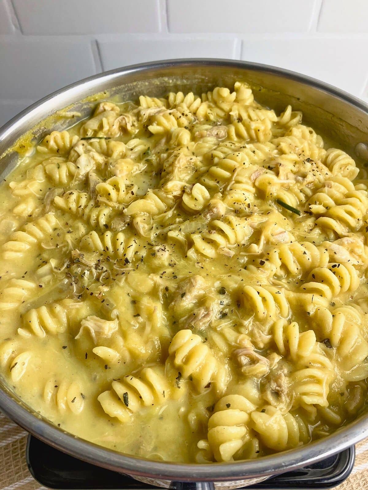 A pot of homemade leftover turkey pumpkin pasta.