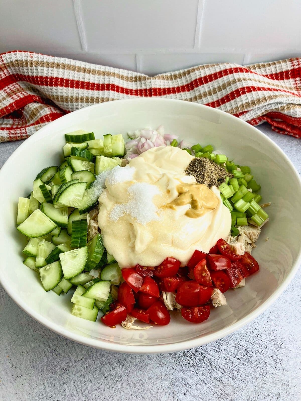 Miracle Whip, mustard, and seasonings were added to the bowl.