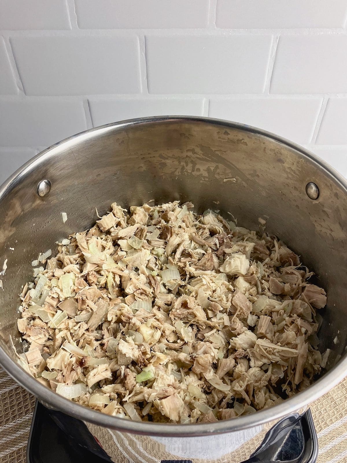 Turkey and vegetables are cooked until the onions are soft.