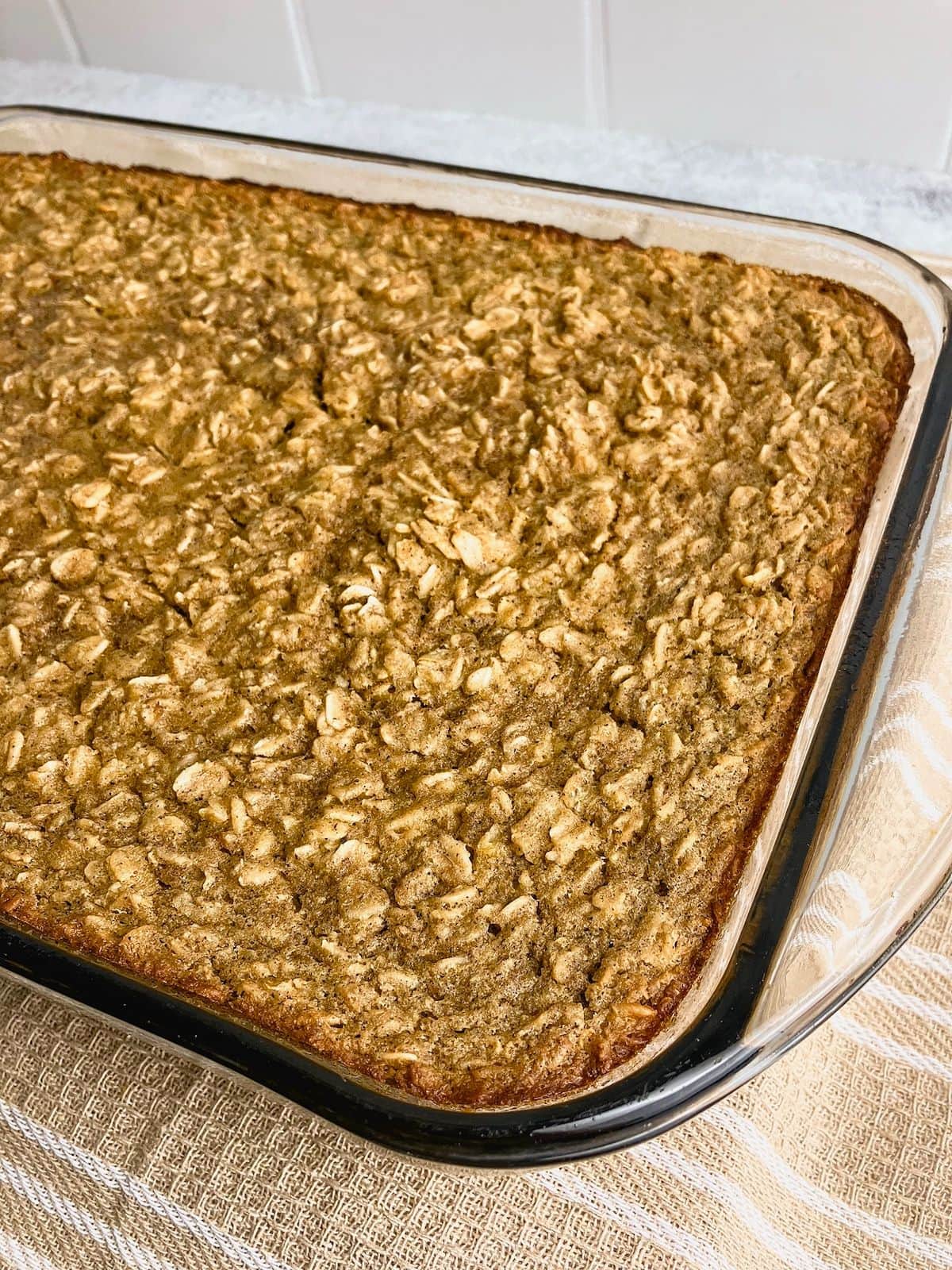 A baking dish of pumpkin baked oatmeal is cooling on the counter.