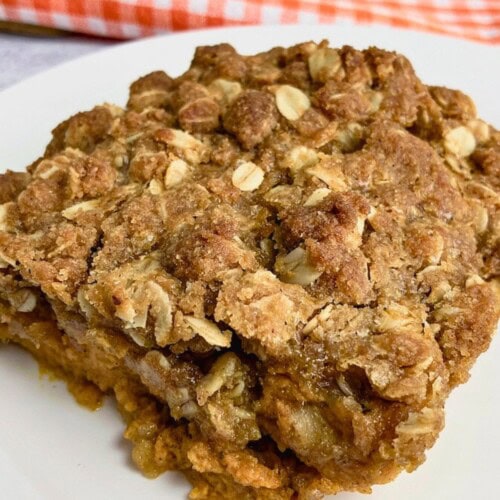 Homemade pumpkin crisp on a white plate.