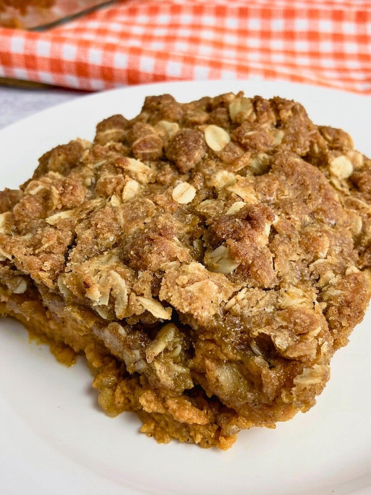 Homemade pumpkin crisp on a white plate.