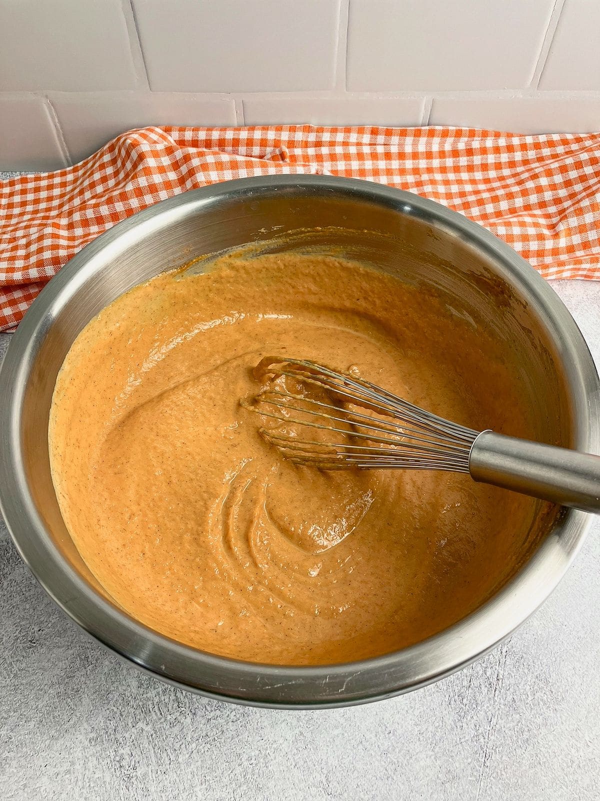 Pumpkin puree and wet ingredients are mixed together.