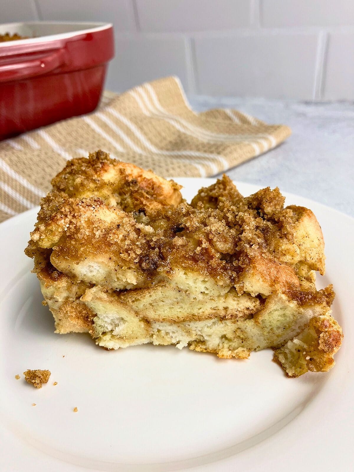 A slice of pumpkin French toast casserole on a white plate.