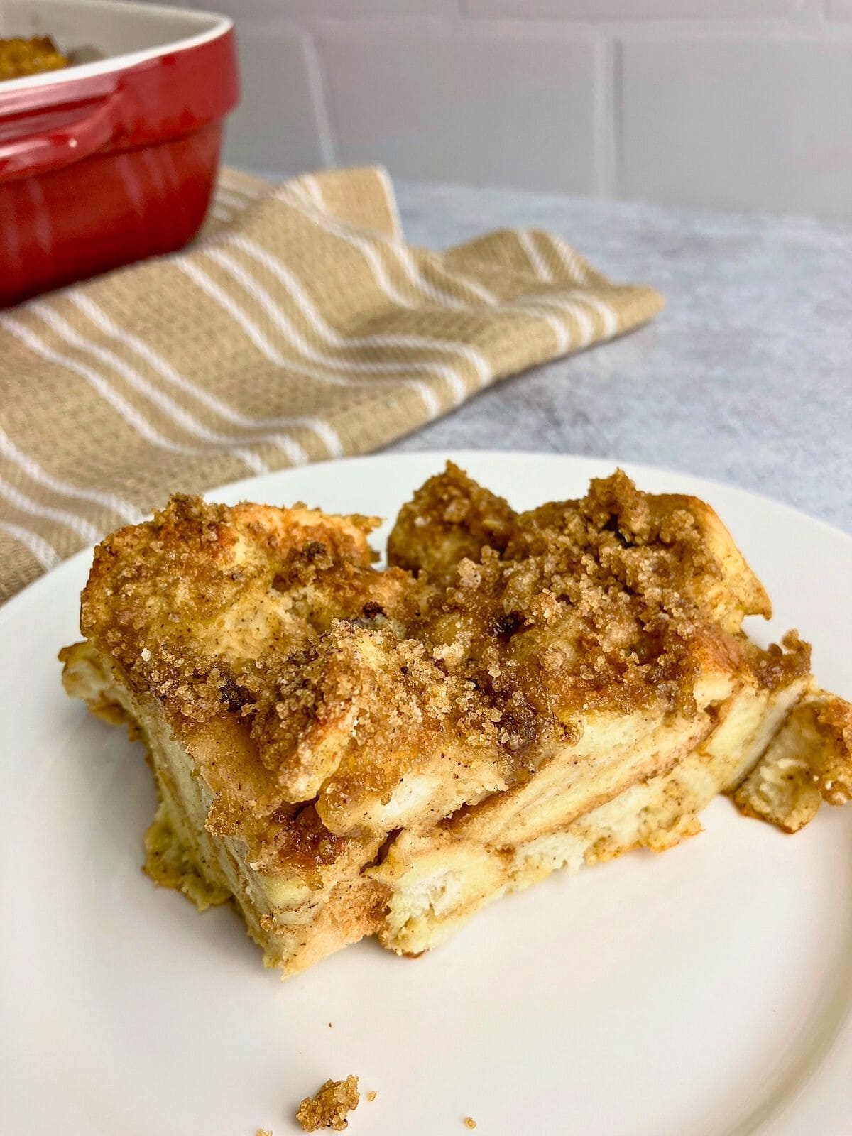 A slice of homemade pumpkin French toast casserole on a white plate.