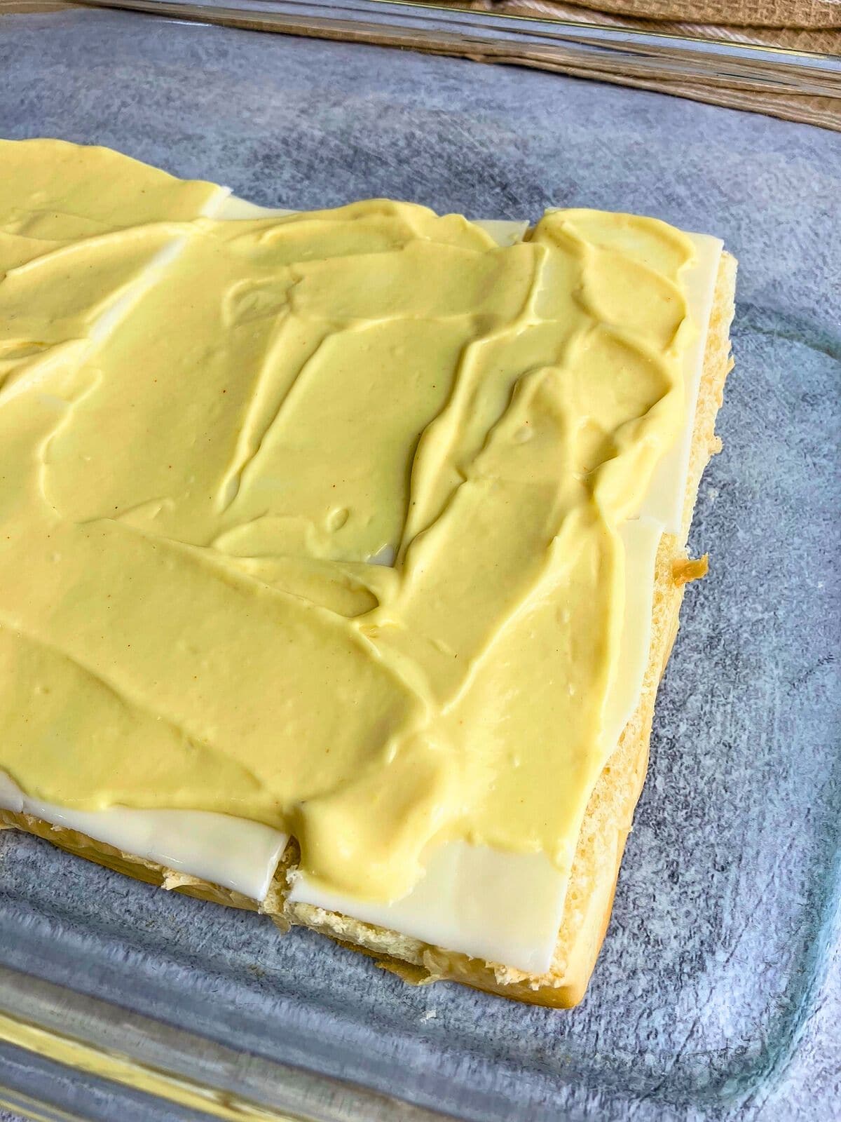 Sauce spread over the sliced cheese.
