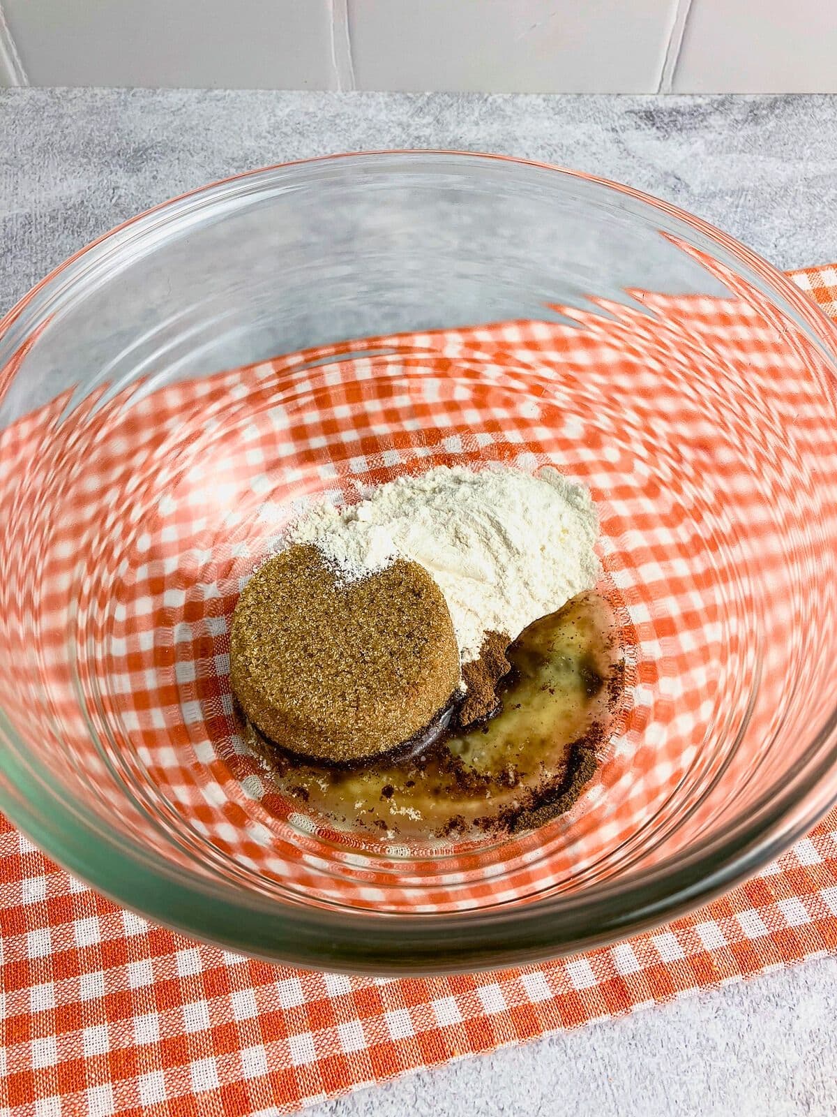 Melted butter, brown sugar, flour, and spices in a mixing bowl.