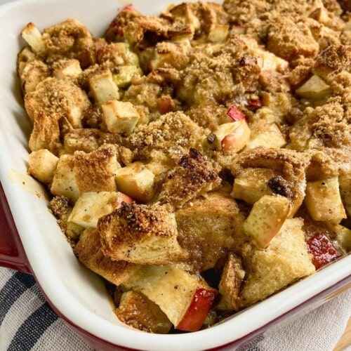 Apple cinnamon French toast casserole in a red and white baking dish.