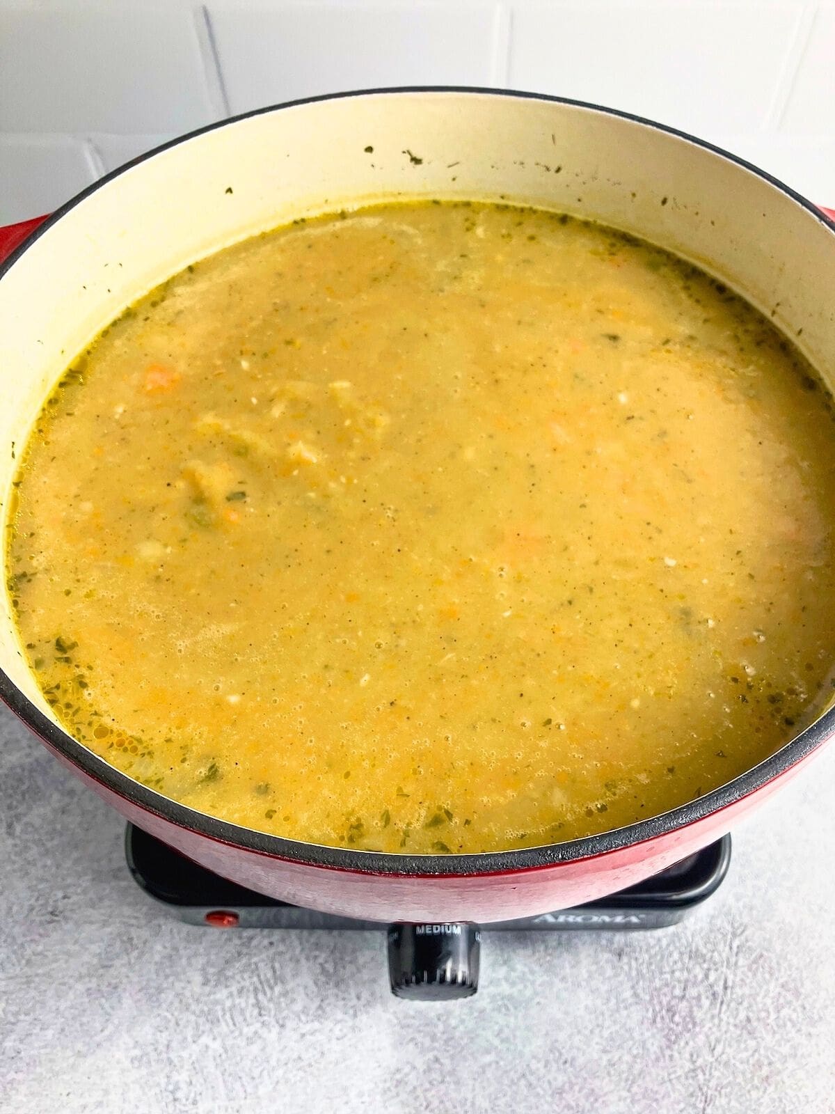 Broth has been added to the pot of vegetables.