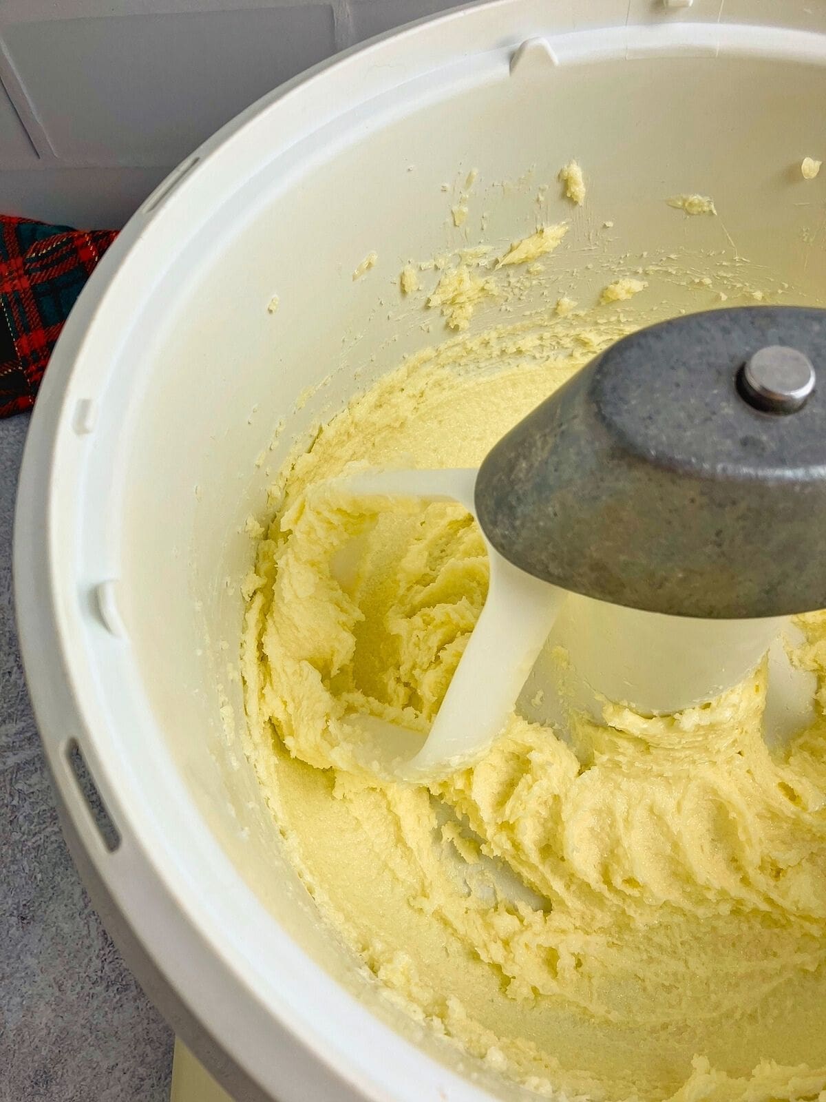 Butter and sugar are creamed together in a mixer bowl.