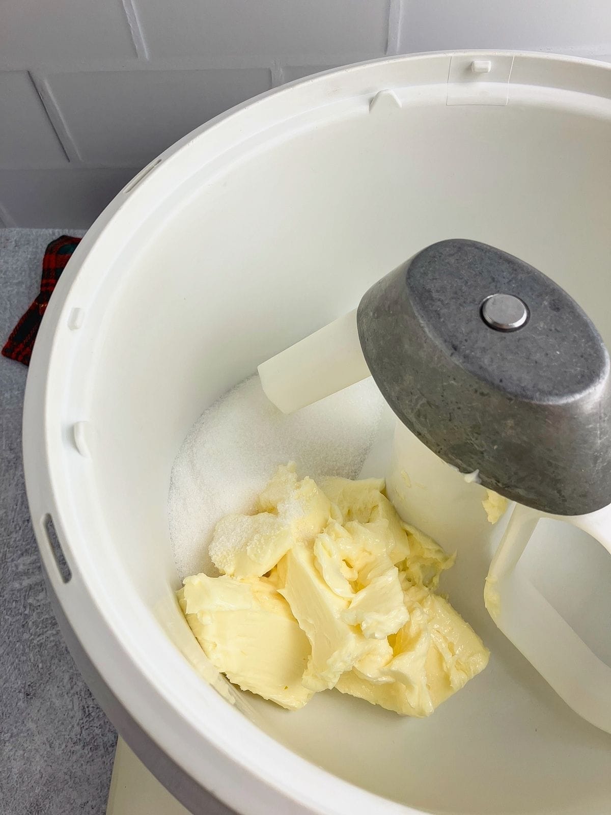 Butter and white sugar in a stand mixer bowl.