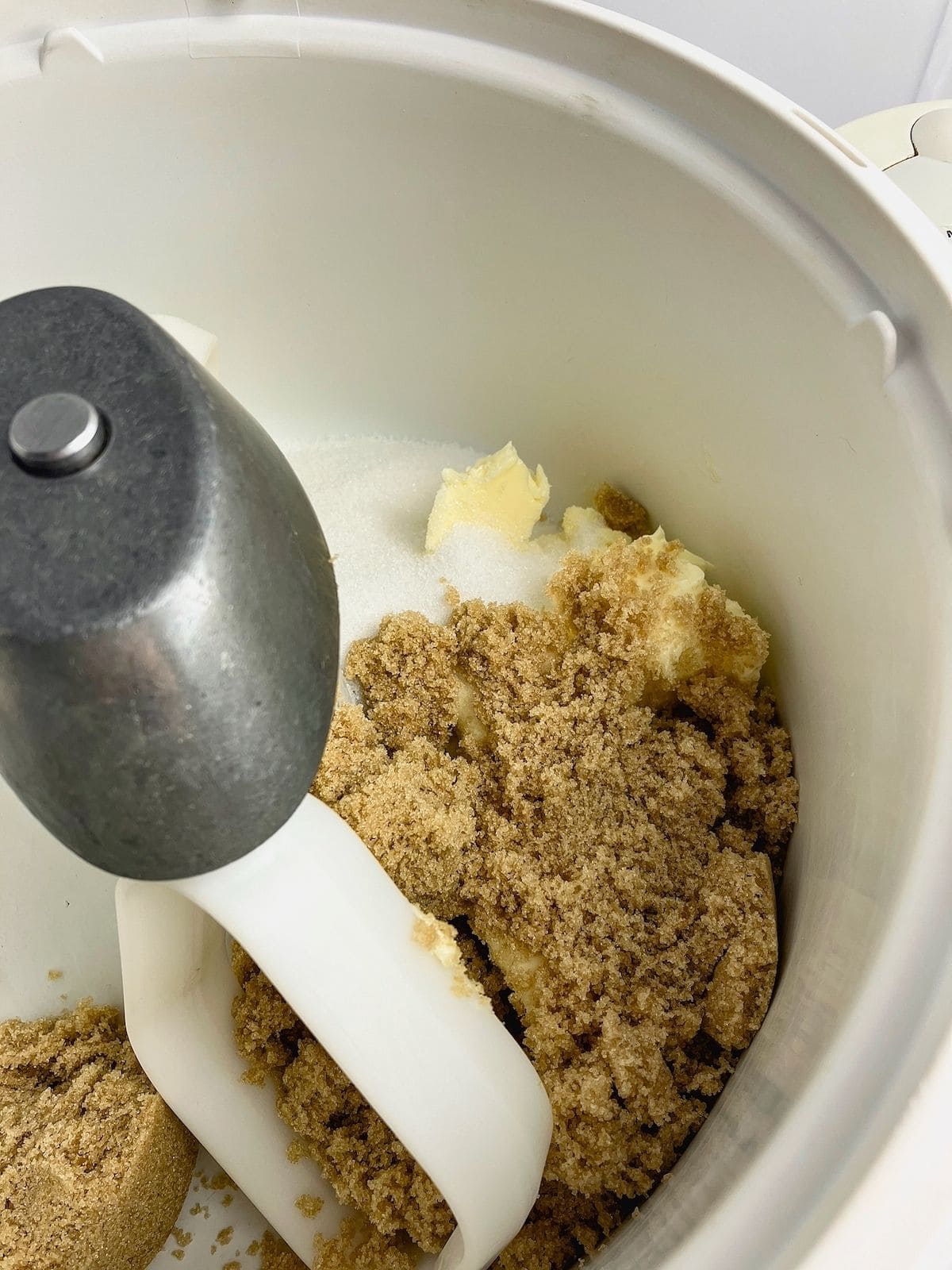 Butter, white sugar, and brown sugar in a mixer bowl.