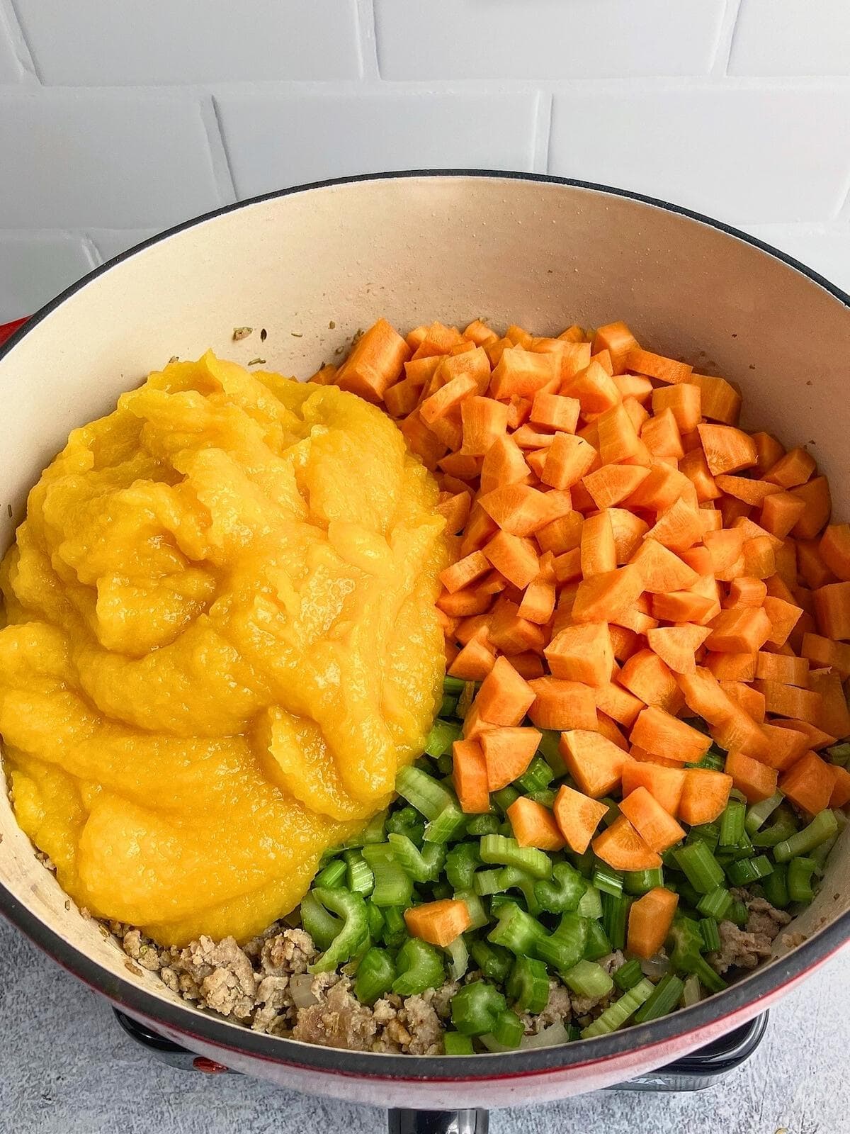 Diced carrots, celery, and pumpkin puree were added to the cooked pork mixture.