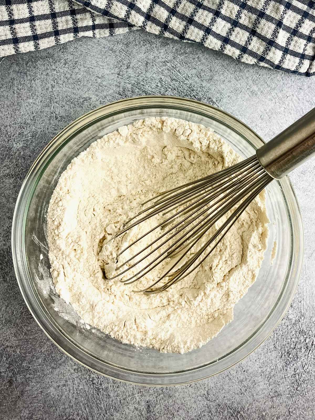Dry ingredients mixed together in a glass mixing bowl.