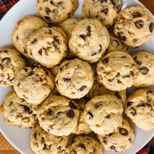 A large white platter of easy homemade chocolate chip walnut cookies.