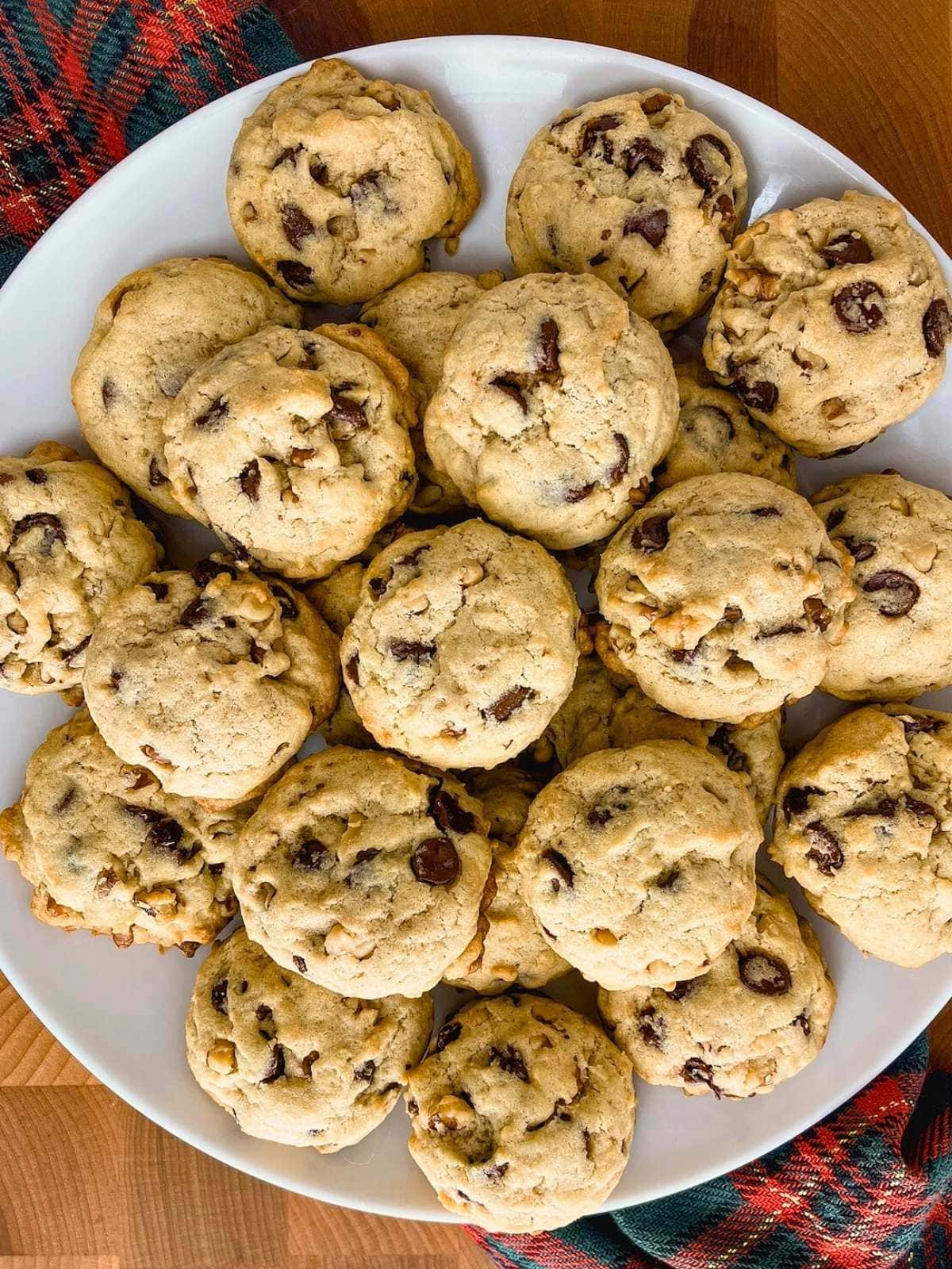 A large white platter of easy homemade chocolate chip walnut cookies.