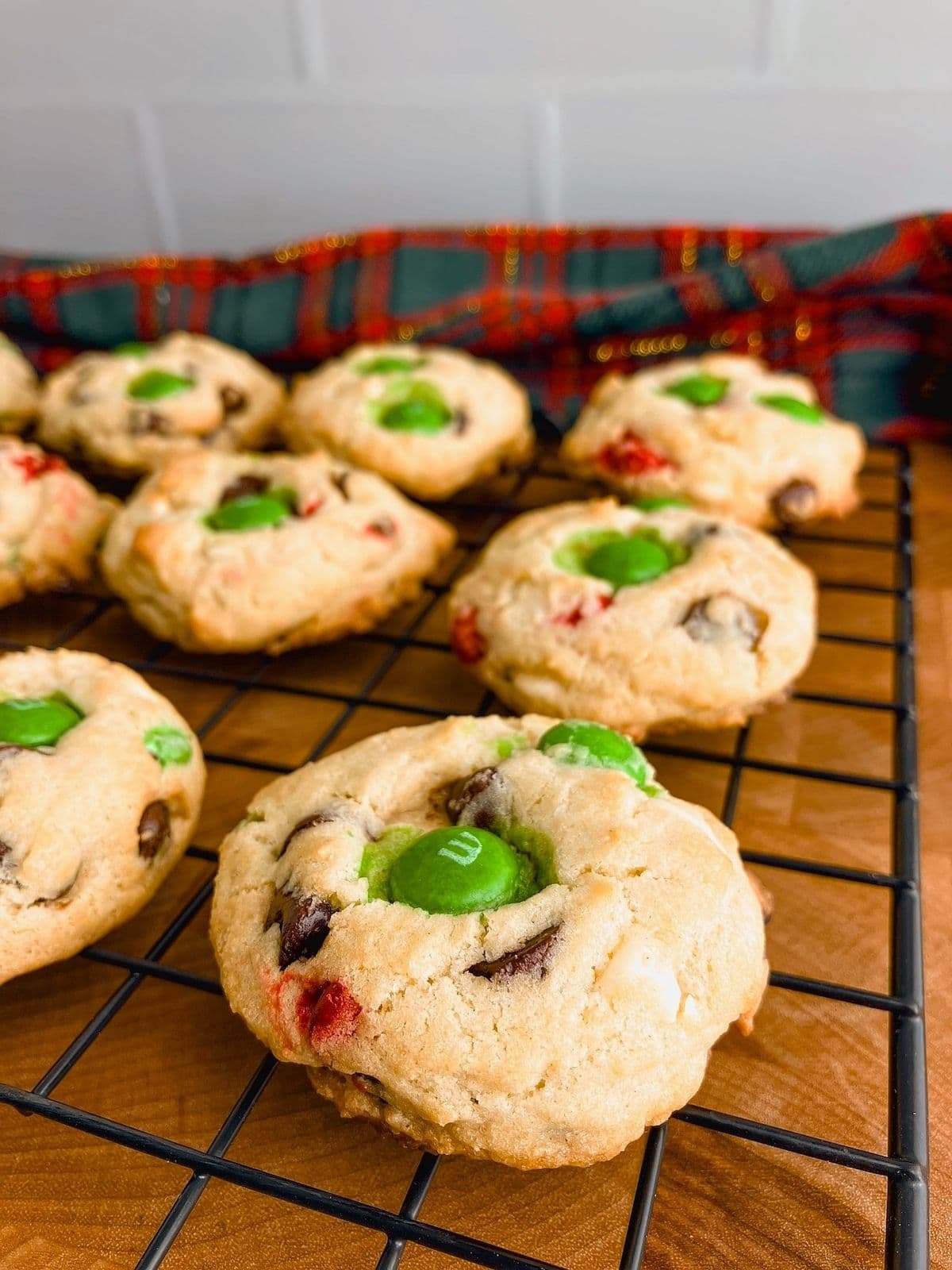 M&M chocolate chip cookies on a cooling rack.