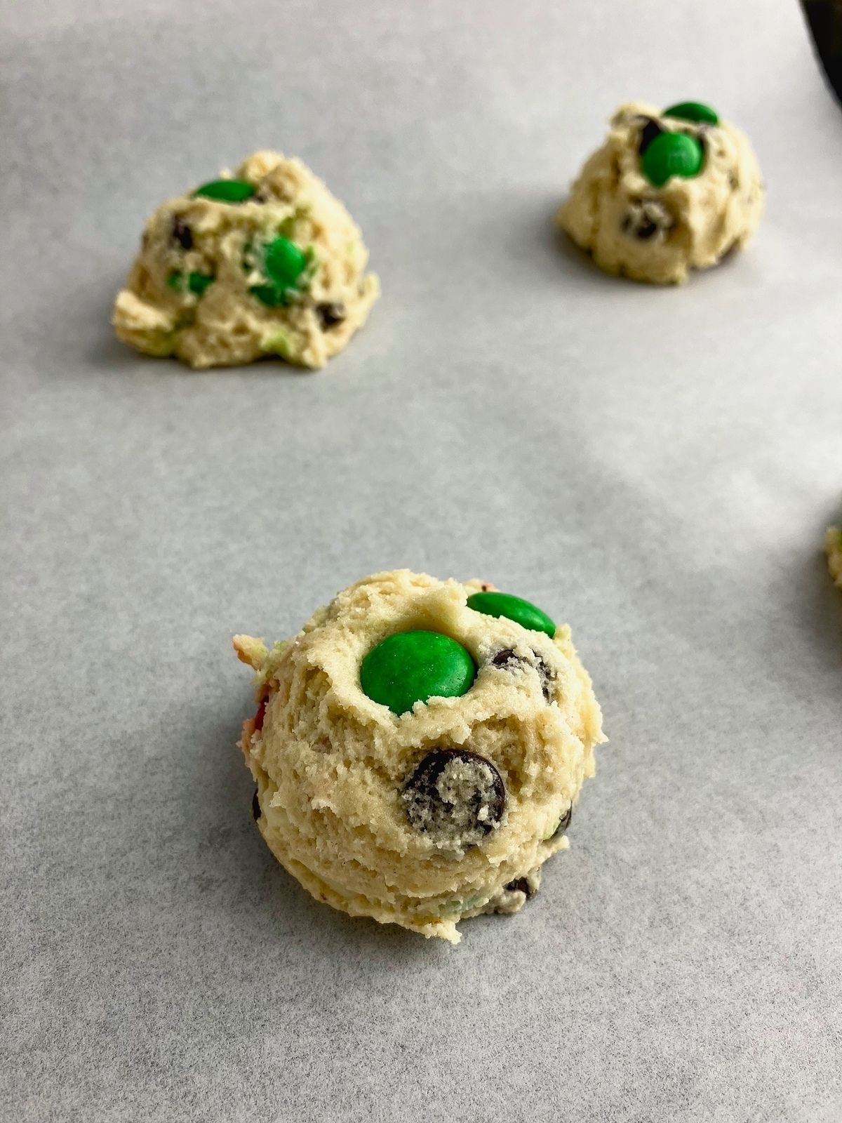 Cookie dough balls on a baking sheet.