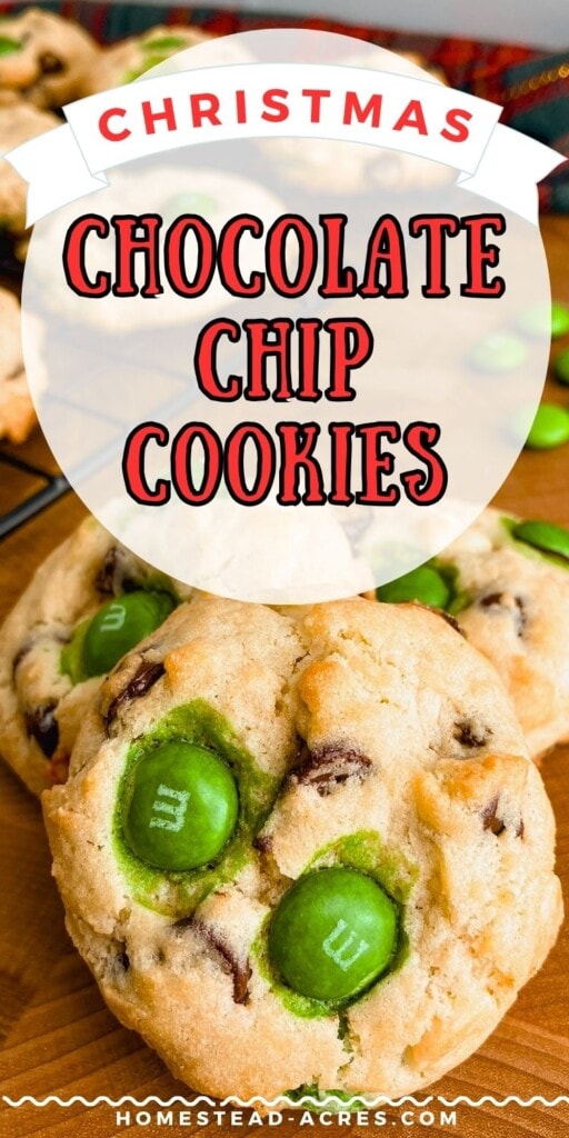 Chocolate chip cookies with M&Ms on a wooden table. The text overlay says Christmas Chocolate Chip Cookies.