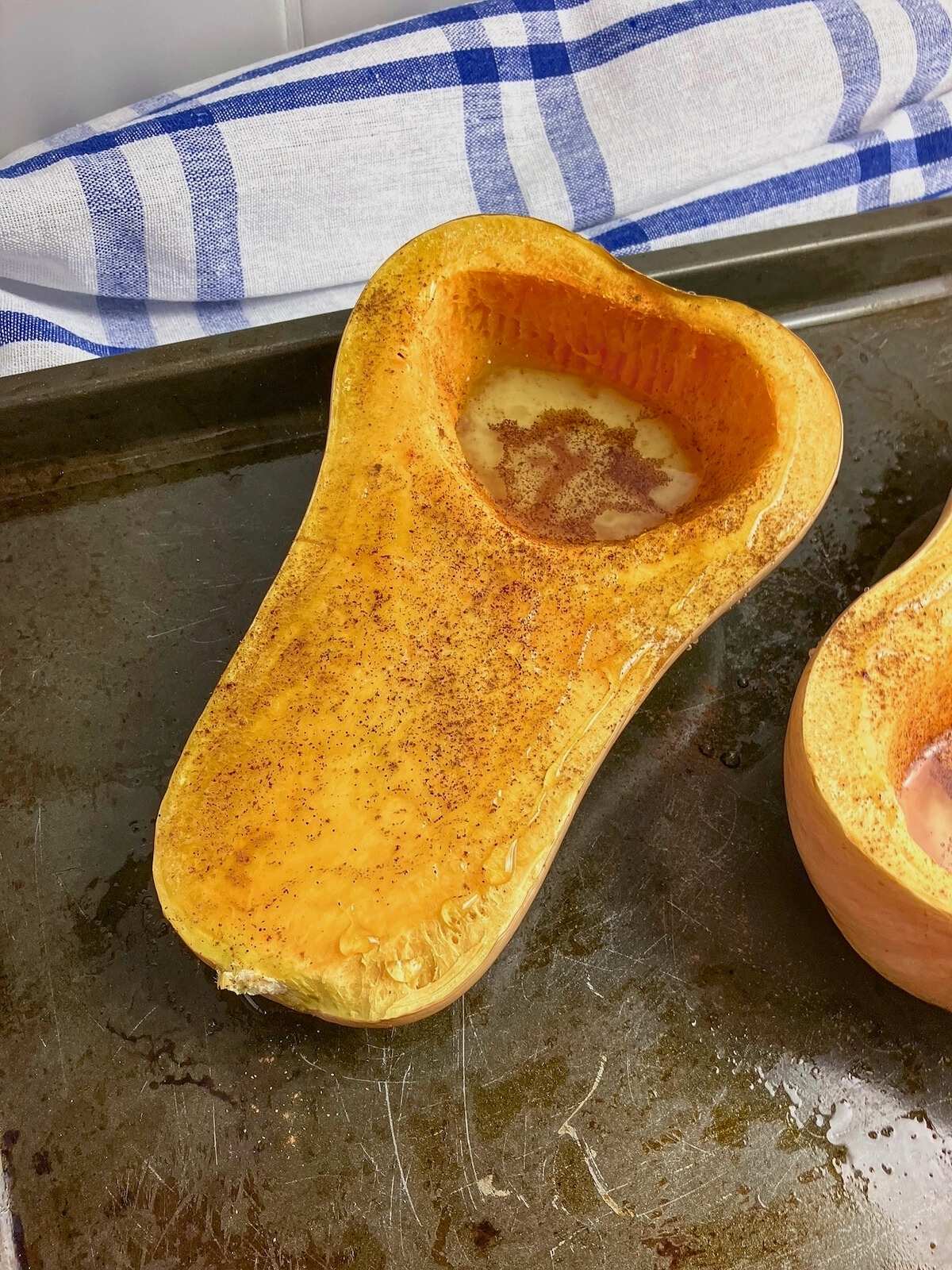 Honey poured over the partly cooked butternut squash halves with ground cinnamon sprinkled over top.