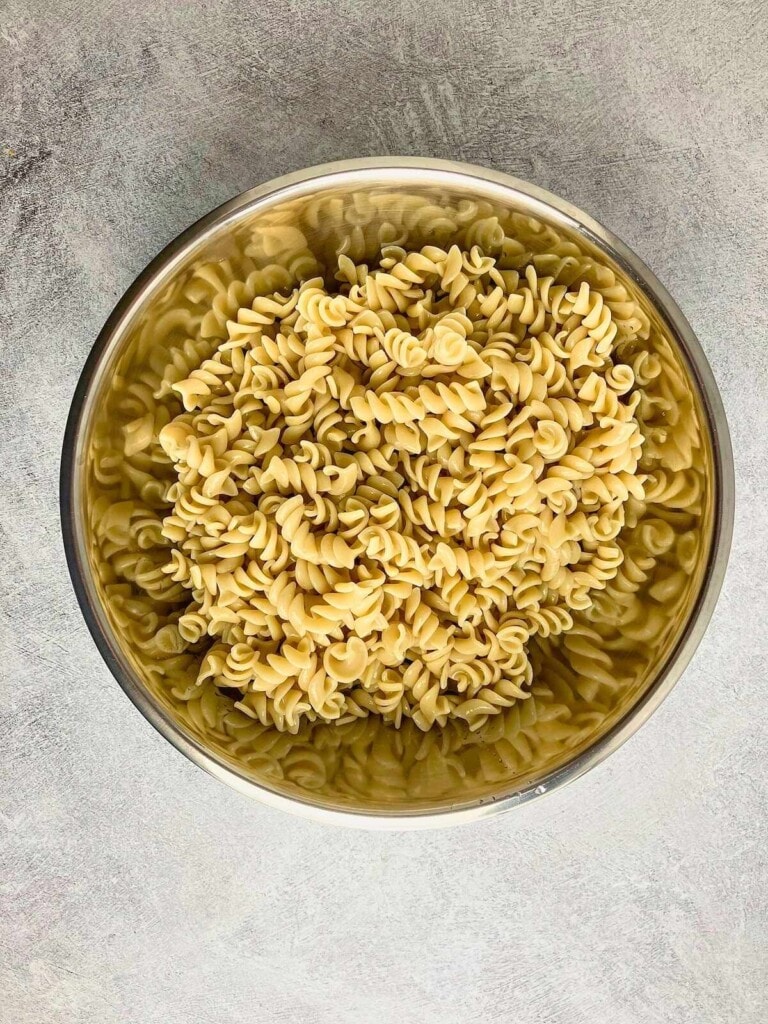 Cooked rotini pasta in a large mixing bowl.