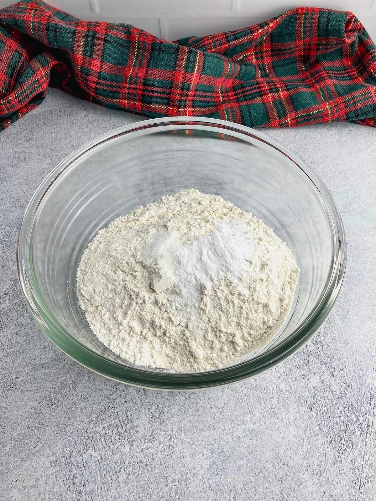 The dry ingredients in a large glass mixing bowl.